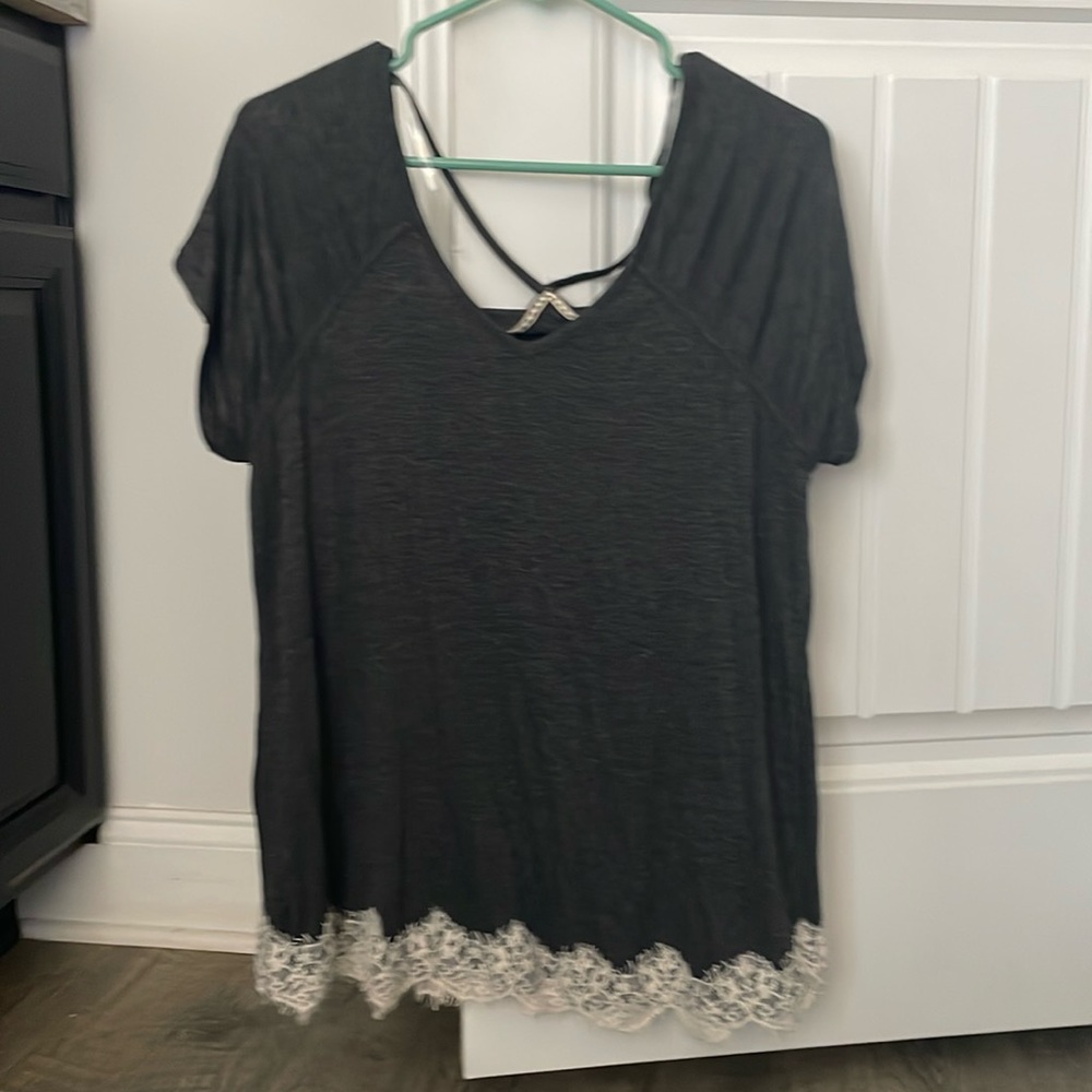 grey shirt with white detailing lining the bottom